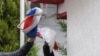 Ukraine -- Volodymyr Parasyuk, former Maidan activist and current Parliament member, tears away a Russian flag from the Russian general consulate during a rally in front of the Russian general consulate in Lviv, 09 March 9, 2016