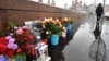 RUSSIA -- People lay flowers at the site where late opposition leader Boris Nemtsov was fatally shot on a bridge near the Kremlin, in central Moscow, February 27, 2020