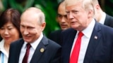 VIETNAM -- U.S. President Donald Trump (R) and Russian President Vladimir Putin talk during the group photo session at the APEC Summit in Danang, Nov. 11, 2017